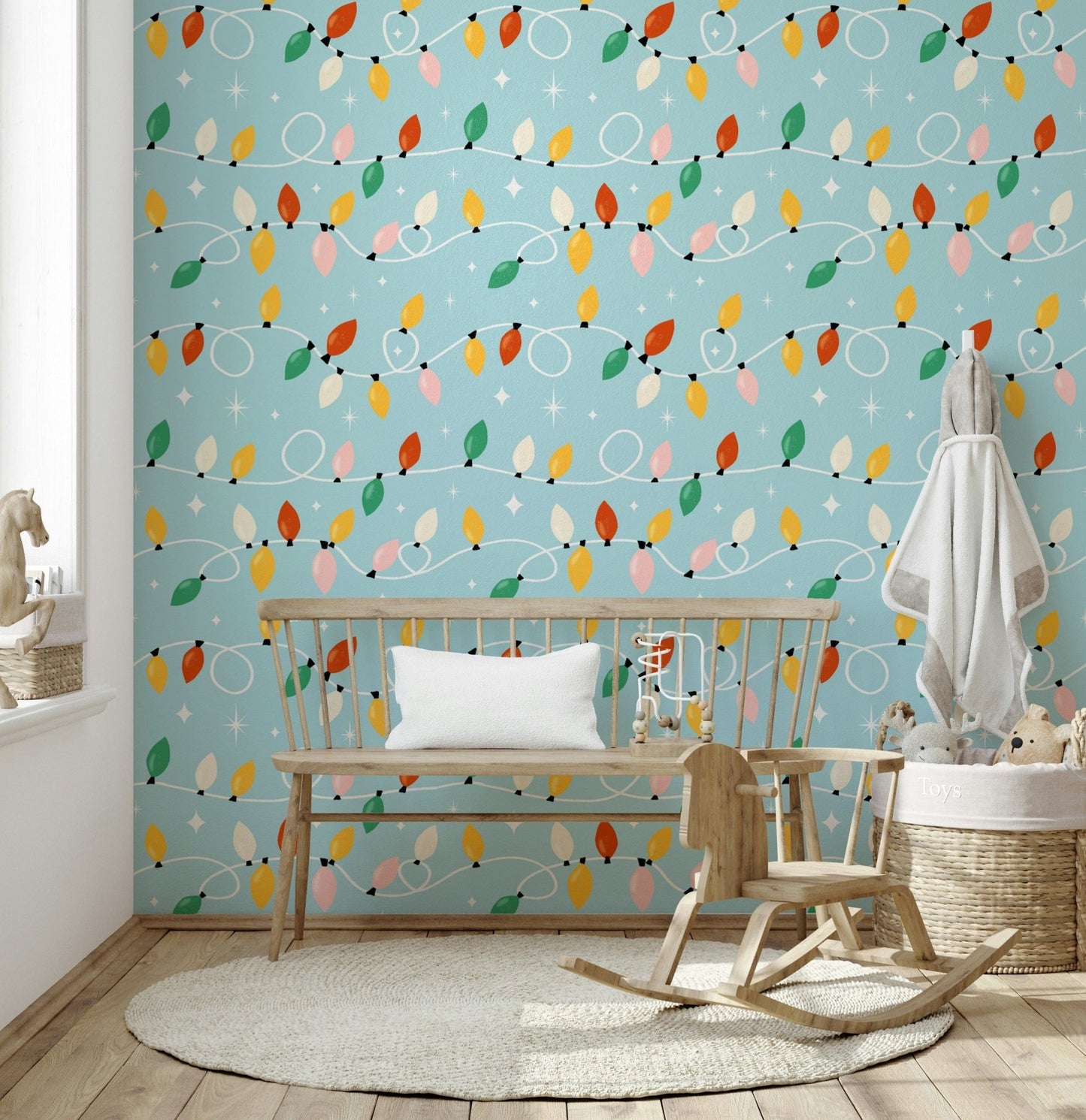 Christmas lights wallpaper featuring vibrant bulbs and scattered star motifs on a soft blue background.