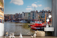 Honfleur Harbor Charm wallpaper mural of the harbor and red boat in a kids room with bookshelves and toys