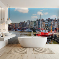 Honfleur Harbor Charm wallpaper mural of the harbor and red boat in a bathroom with a white tub and twin sinks