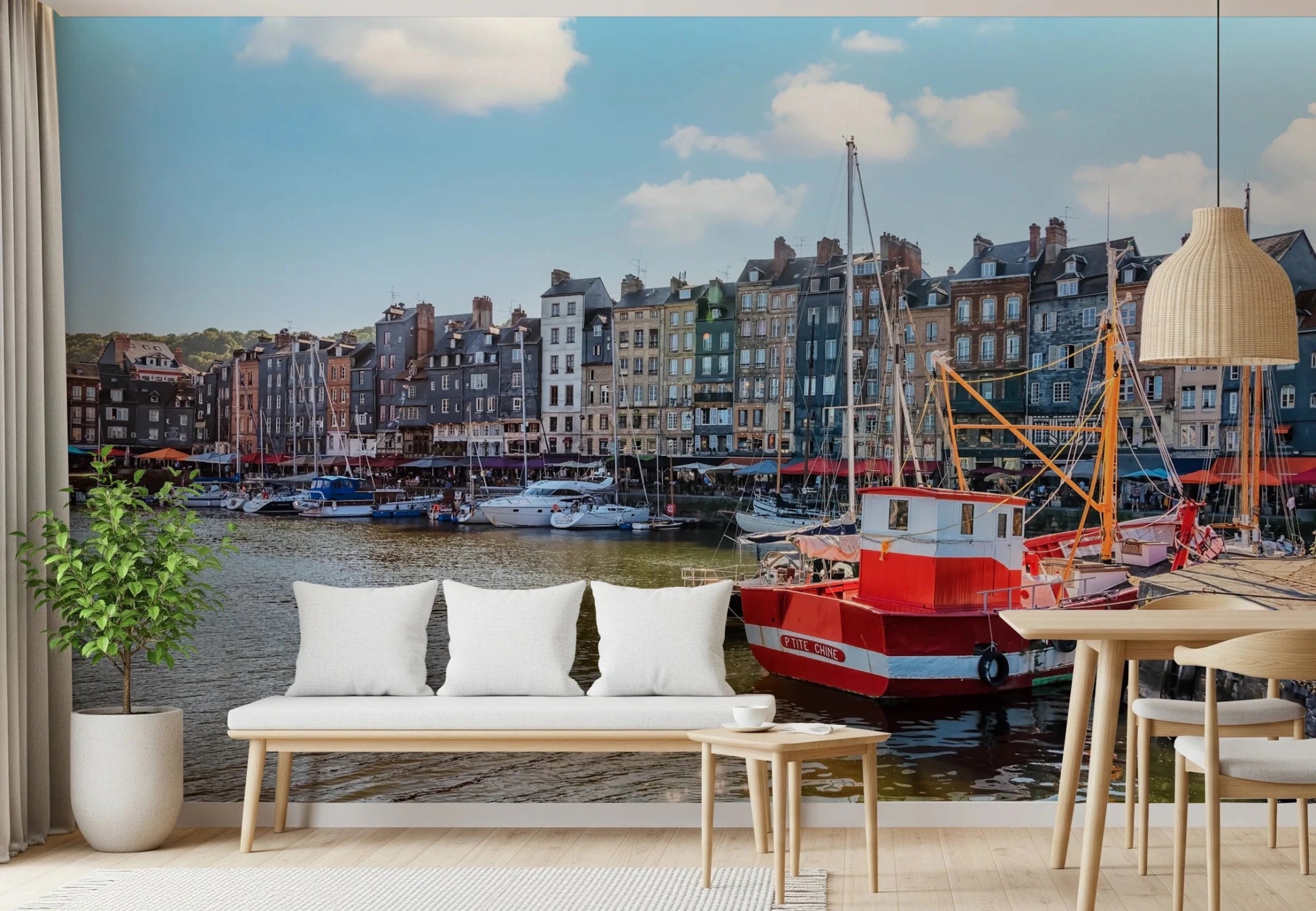 Honfleur Harbor Charm wallpaper mural of the harbor and tall houses behind a white cushioned bench and potted tree