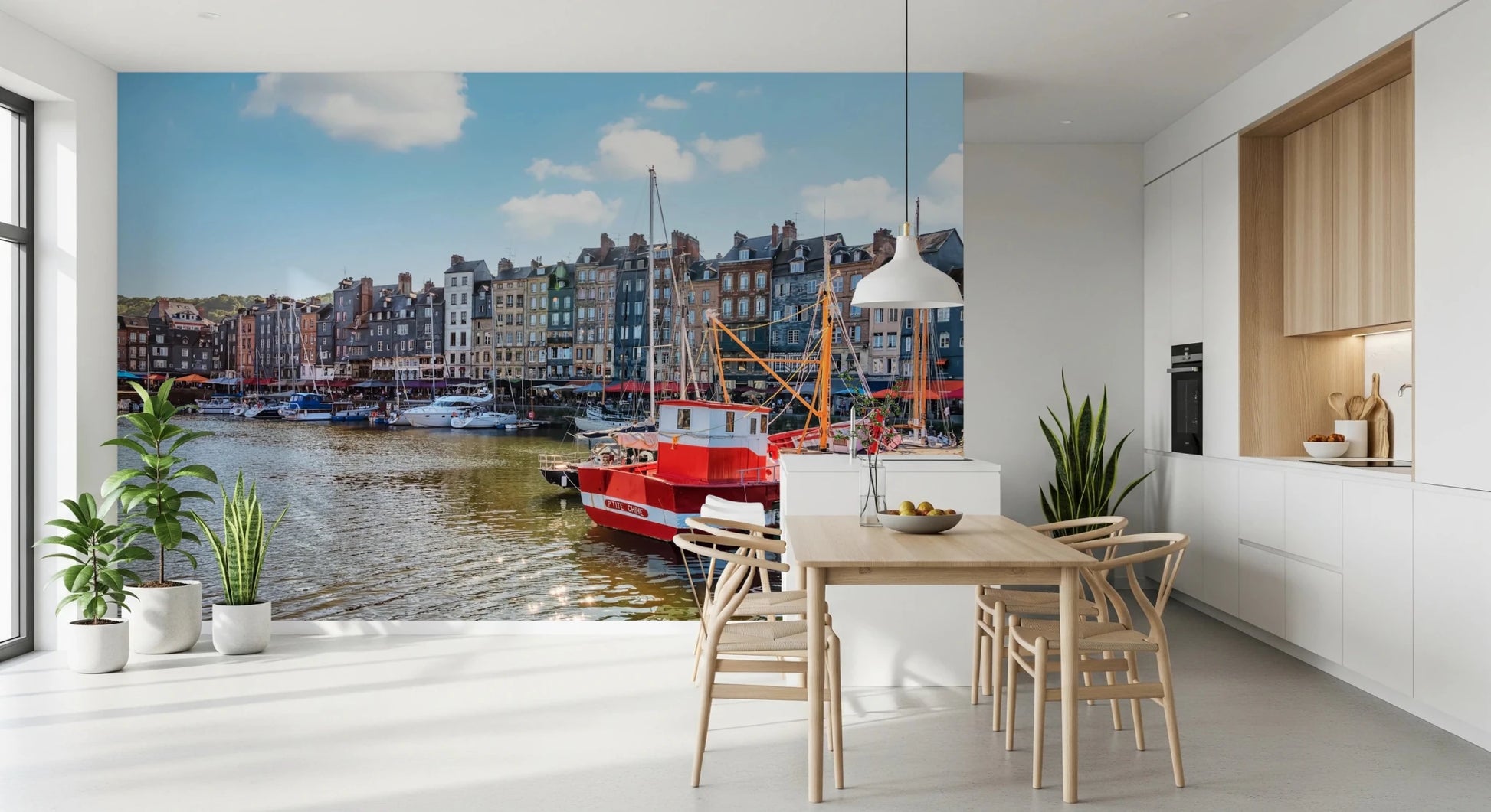 Honfleur Harbor Charm wallpaper mural of the harbor and red boat in a kitchen with a wood table and wishbone chairs