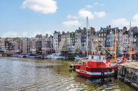 Honfleur Harbor Charm wallpaper mural shown as a full-wall view of the harbor, townhouses and red fishing boat