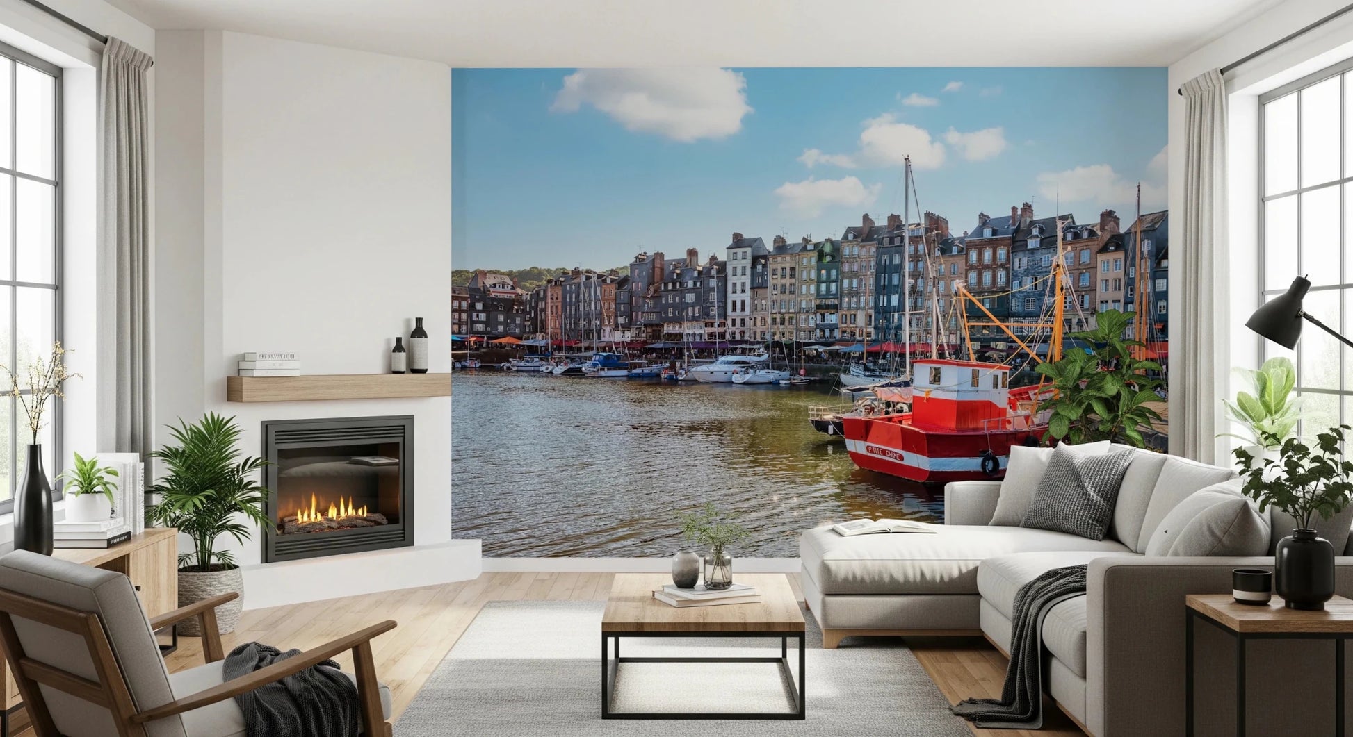 Honfleur Harbor Charm wallpaper mural of the harbor and red boat behind a white sectional beside a fireplace