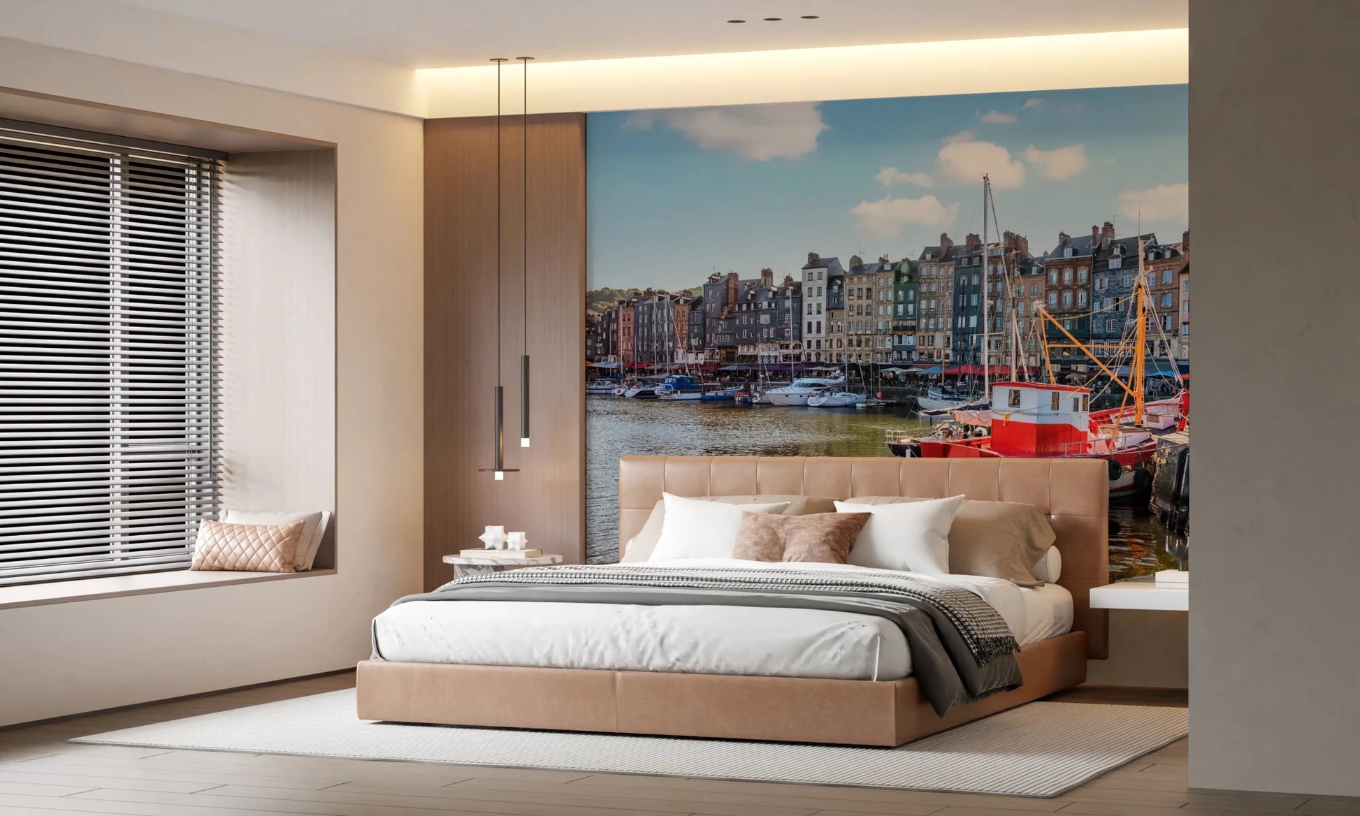 Honfleur Harbor Charm wallpaper mural of the sunny harbor and red boat behind a tan leather bed in a bedroom