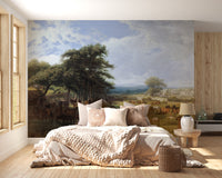 Horse Meadow wallpaper mural with horses grazing under trees behind a cream upholstered bed in a cozy bedroom