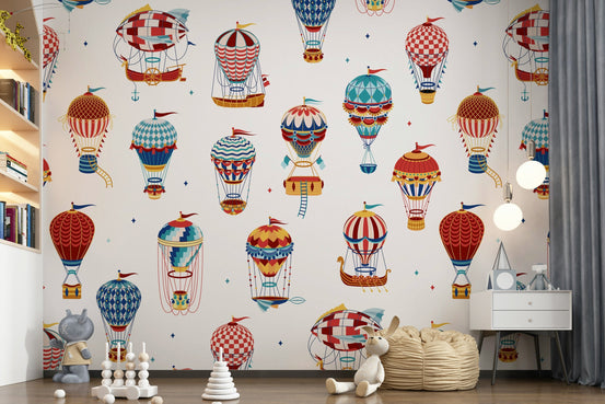 Up, Up and Away wallpaper mural of vintage red and blue hot air balloons on cream in a kids room with bookshelf and bean bag