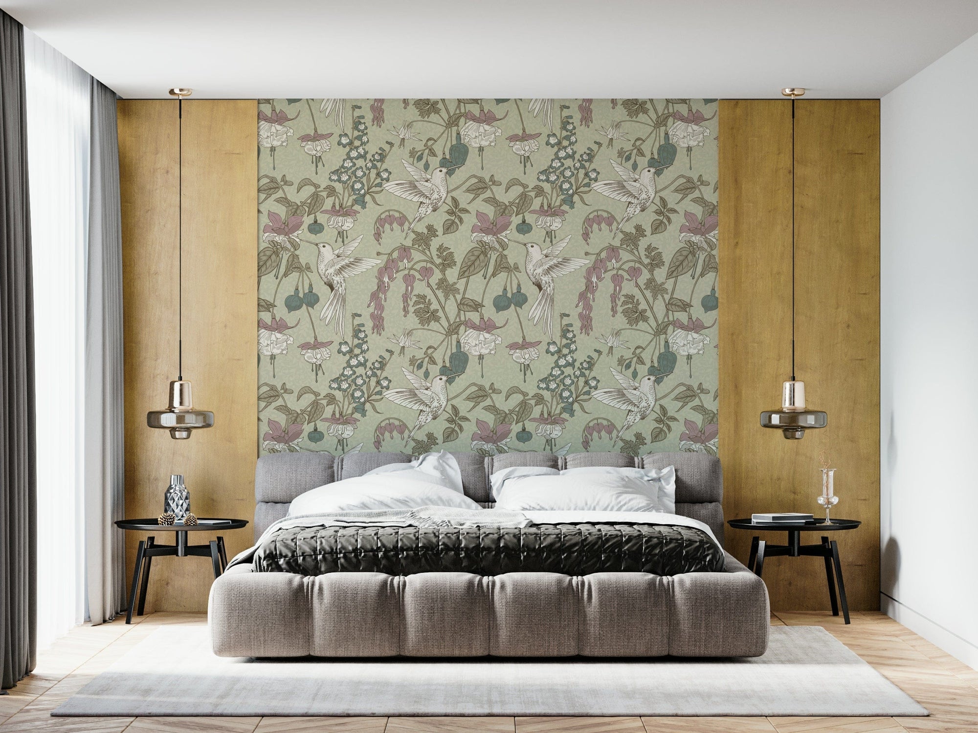 Hummingbird Harmony wallpaper of sage-green botanical hummingbirds and pink fuchsia flowers behind a gray tufted bed in a bedroom