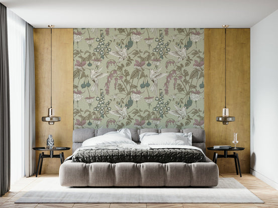 Hummingbird Harmony wallpaper of sage-green botanical hummingbirds and pink fuchsia flowers behind a gray tufted bed in a bedroom