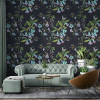 An artistic hummingbird mural on lush wallpaper.


