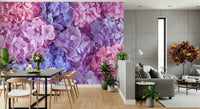 Hydrangea Hues wallpaper mural of pink and blue hydrangeas in a dining room with a dark table and wishbone chairs