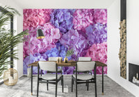 Hydrangea Hues wallpaper mural of vivid hydrangea flowers in a dining room with white chairs and a black arc lamp