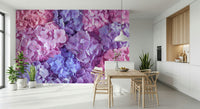 Hydrangea Hues wallpaper mural of bright hydrangeas in a white kitchen-dining room with a wood table and wishbone chairs
