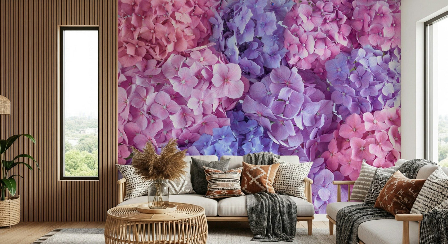 Hydrangea Hues wallpaper mural of pink and purple hydrangea blooms in a living room with a white sofa and boho pillows