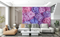 Hydrangea Hues wallpaper mural of pink and purple hydrangeas behind a tan chaise and grey sectional in a living room