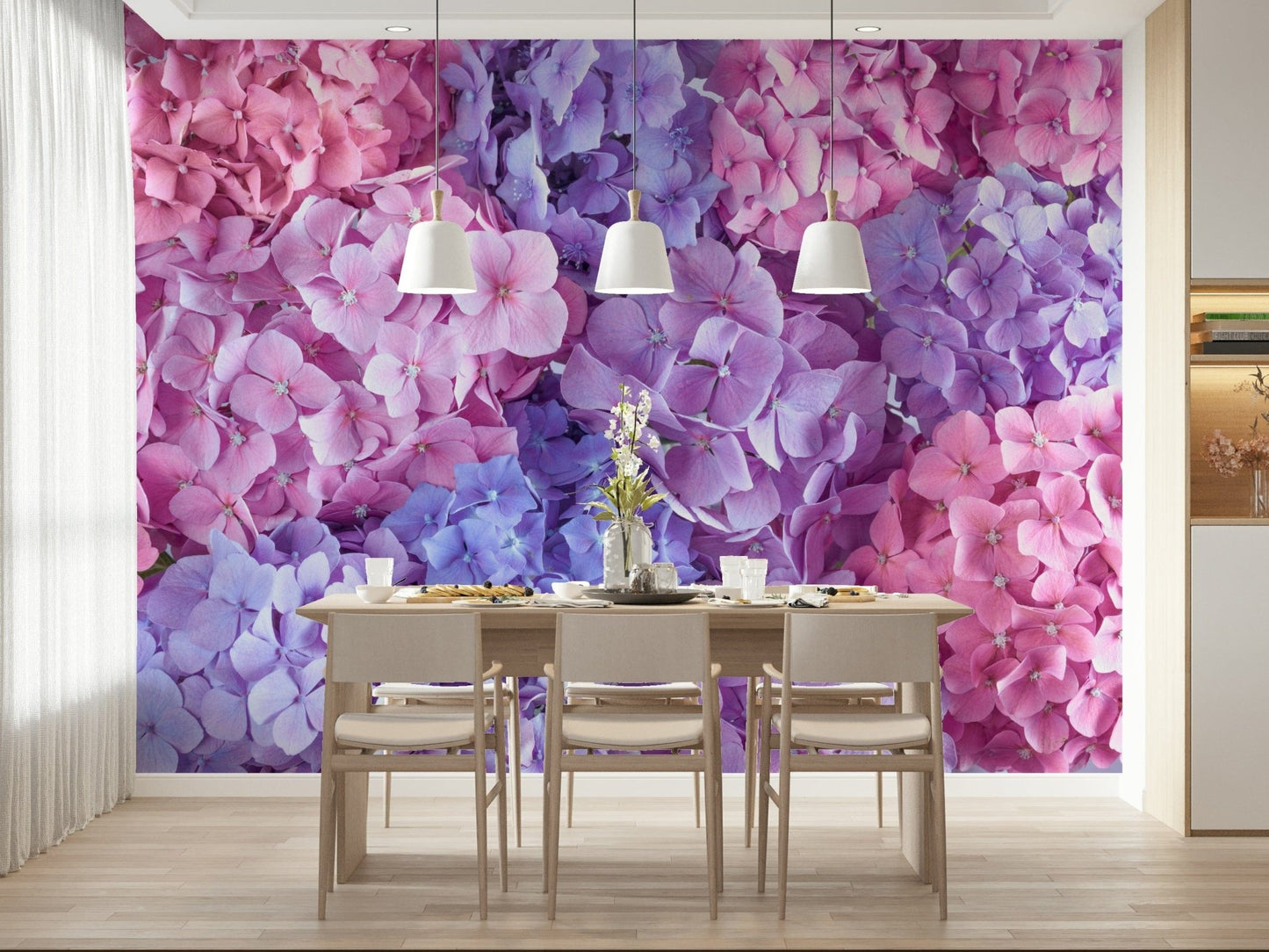 Hydrangea Hues wallpaper mural of pink and purple blooms in a dining room with a wood table and white pendant lamps