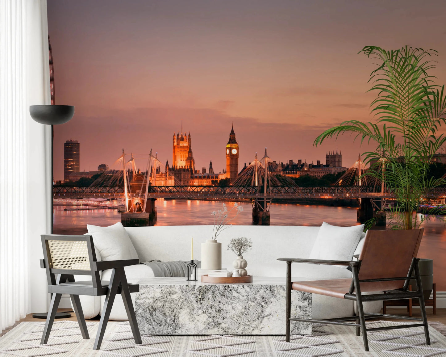 Iconic London at Dusk wall mural of the glowing skyline above a white sofa and marble table with leather and cane chairs