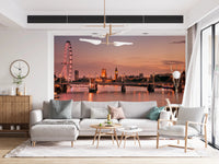 Iconic London at Dusk wall mural of the Thames skyline behind a grey sectional under a gold chandelier in a living room