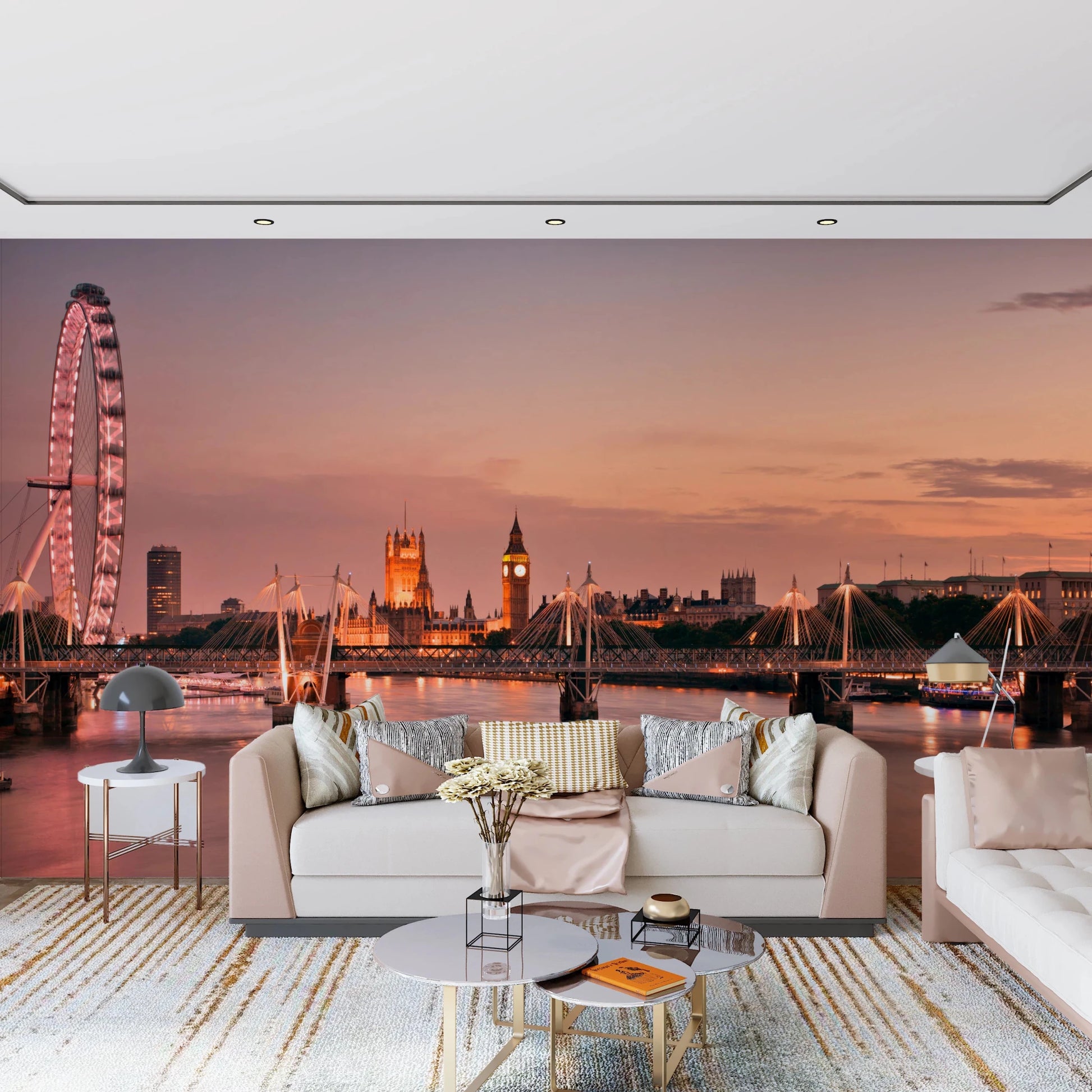 Iconic London at Dusk wall mural of the Thames skyline at sunset behind a cream sofa and gold coffee tables in a living room