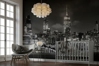 Hudson River reflections under high-rise cityscape mural

