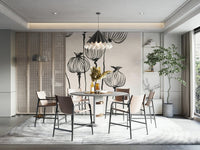 Ink Poppy Pods wallpaper mural of sketched pods behind a round terrazzo dining table with tan chairs