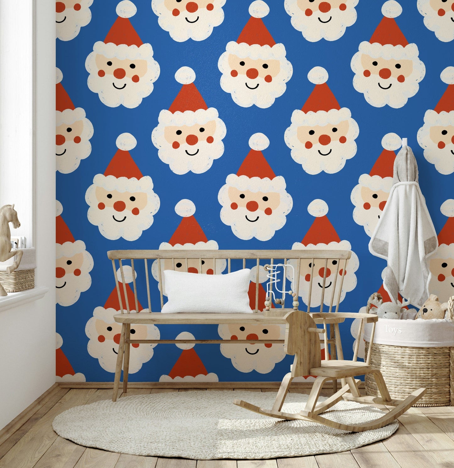 Blue holiday wallpaper covered in happy Santa faces with rosy cheeks and fluffy beards.