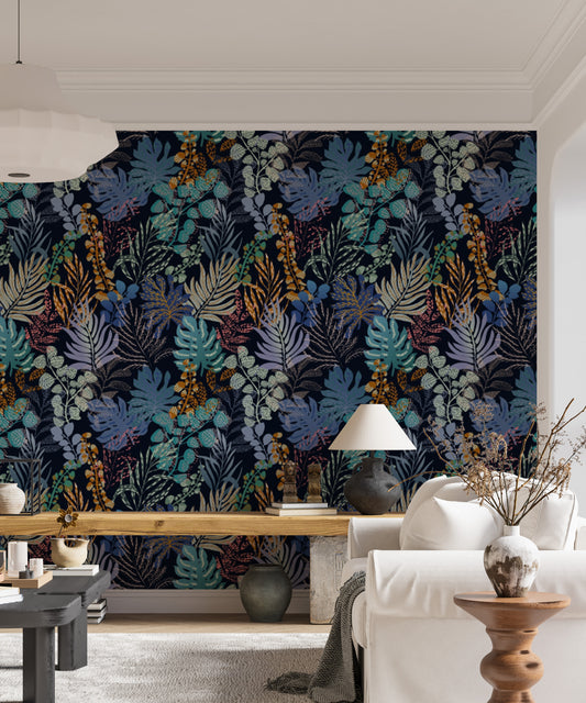 Jungle Night Symphony wallpaper in navy blue and orange foliage behind a white sofa and wood console in a living room