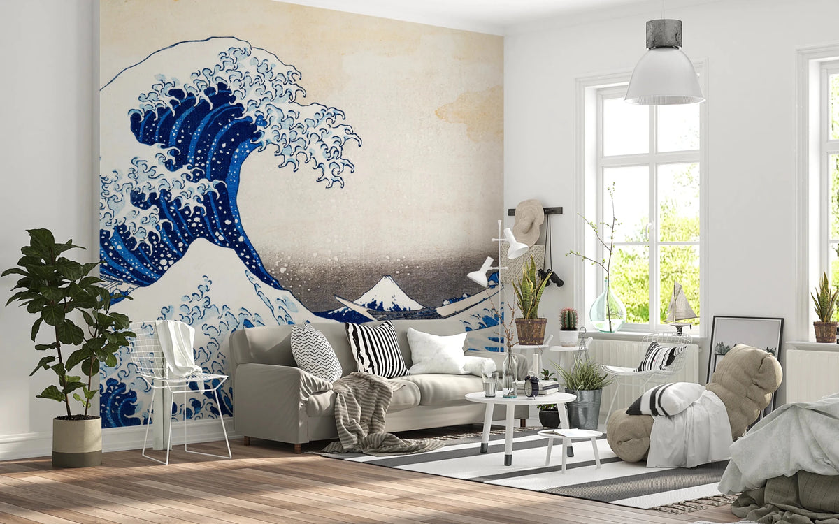 Katsushika Hokusai's The Great Wave off Kanagawa wallpaper mural with the blue wave behind a cream sofa and white wire chair in a living room