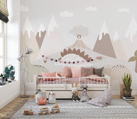 Jurassic Landscape wallpaper mural in soft pastels behind a cream daybed with blush pillows in a child's bedroom