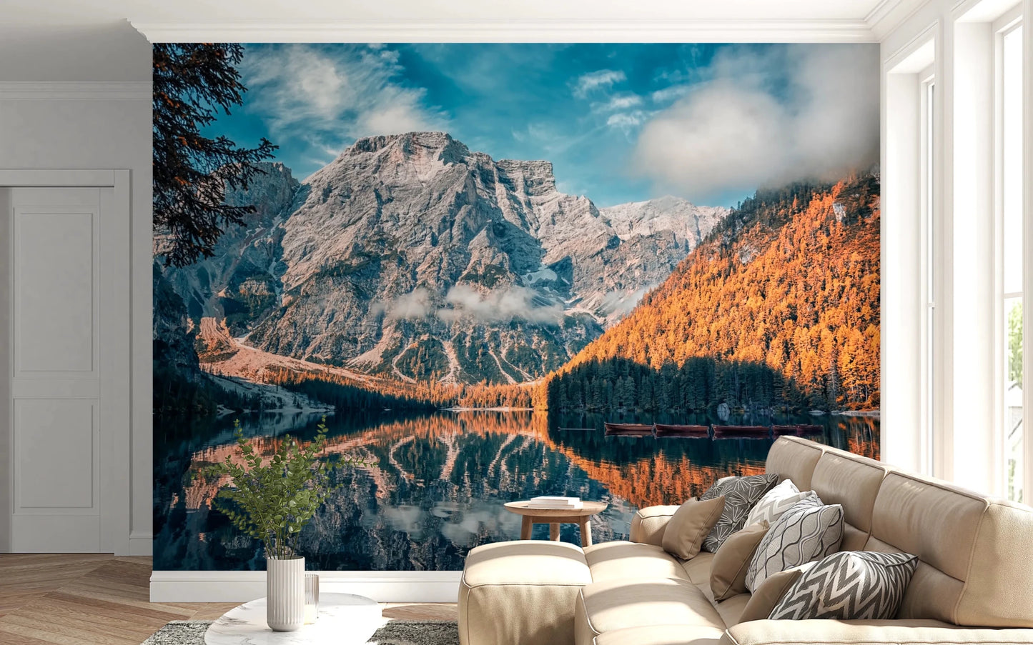 Lake Braies Serenity wallpaper mural of the reflecting lake and autumn larches behind a cream sofa in a bright living room