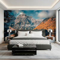 Lake Braies Serenity wallpaper mural of mountain and amber forest above a dark upholstered bed with chrome lamps in a bedroom
