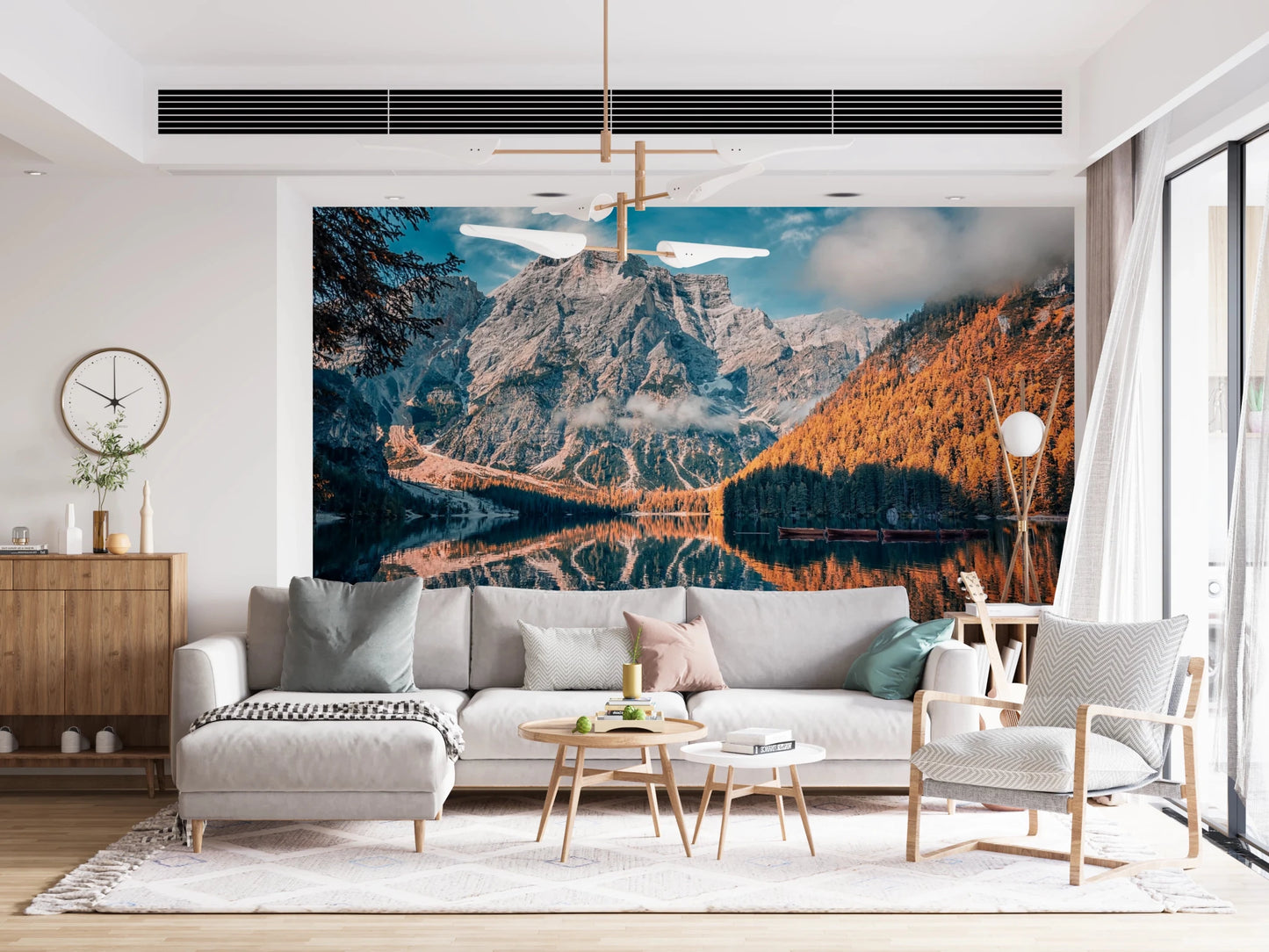 Lake Braies Serenity wallpaper mural of the reflecting alpine lake behind a grey sectional sofa and wood sideboard in a living room