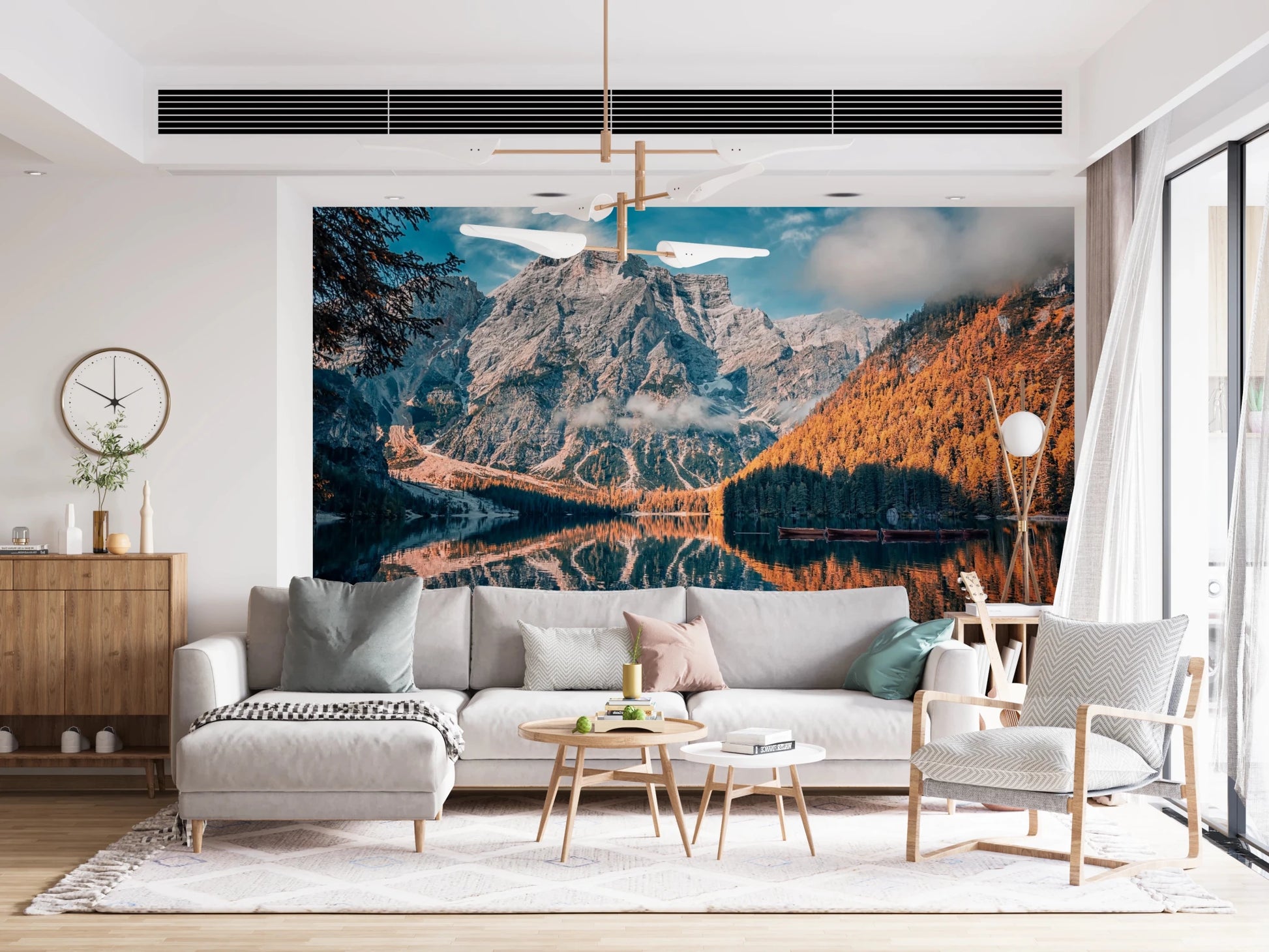 Lake Braies Serenity wallpaper mural of the reflecting alpine lake behind a grey sectional sofa and wood sideboard in a living room