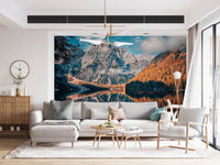 Lake Braies Serenity wallpaper mural of the reflecting alpine lake behind a grey sectional sofa and wood sideboard in a living room
