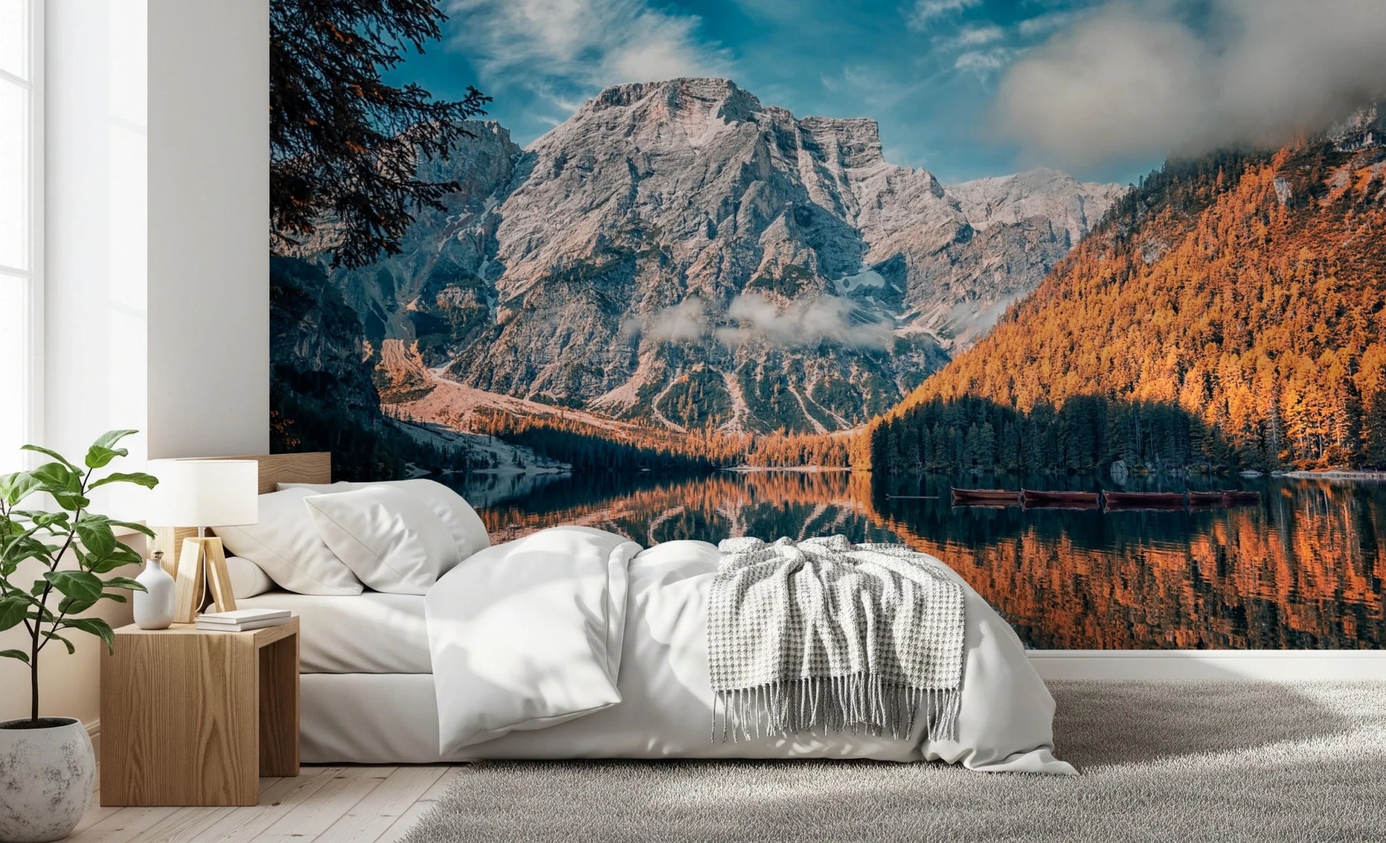 Lake Braies Serenity wallpaper mural showing the rocky mountain and orange larch forest above a white bed in a bright bedroom