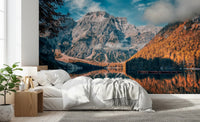 Lake Braies Serenity wallpaper mural showing the rocky mountain and orange larch forest above a white bed in a bright bedroom