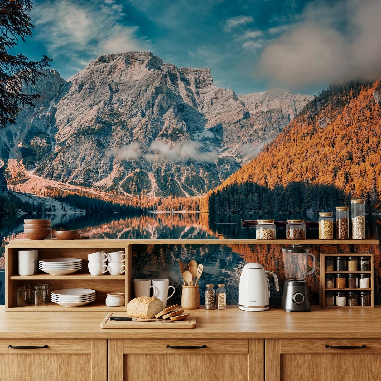 Lake Braies Serenity wallpaper mural with grey peak and autumn woods above a wood kitchen counter with dishes and kettle