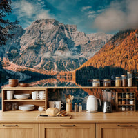 Lake Braies Serenity wallpaper mural with grey peak and autumn woods above a wood kitchen counter with dishes and kettle