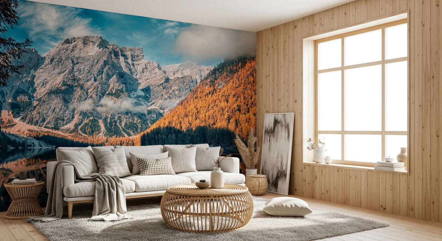Lake Braies Serenity wallpaper mural with rocky mountain and orange forest above a white sofa by a wood-panelled wall and window
