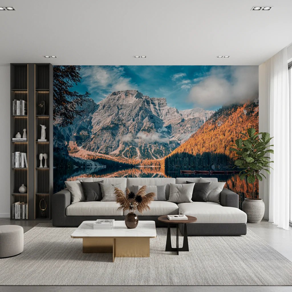 Lake Braies Serenity wallpaper mural showing the calm lake and Dolomite peak behind a grey sofa beside a tall plant in a living room