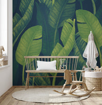 Deep Green Banana leaf wallpaper mural as a feature wall in a home office workspace in green tones