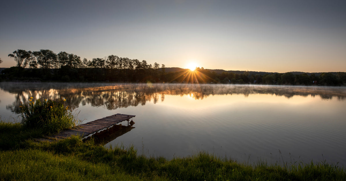 Tranquil Sunrise Reflection Over Serene Lake Wall Mural in your room — zoomed