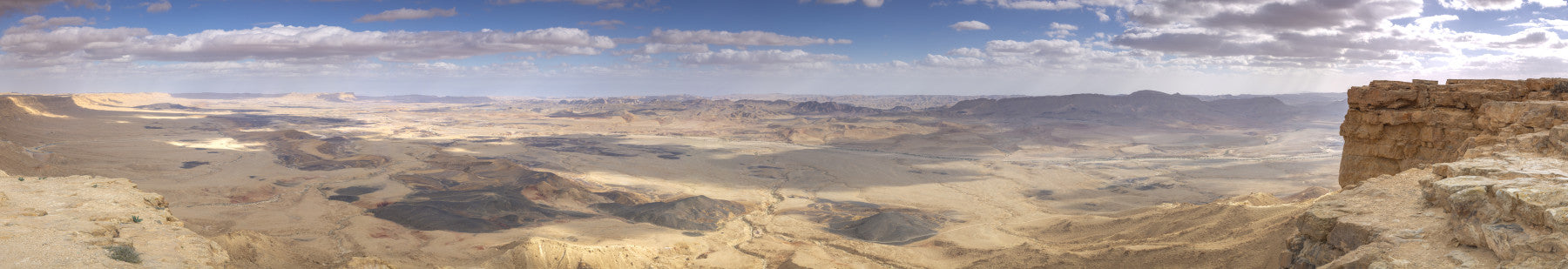 The terrain includes sand dunes or rocky formations.

