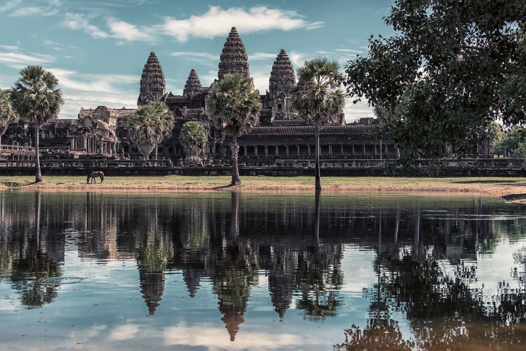 A beautiful Angkor Wat wallpaper mural reflecting in water.


