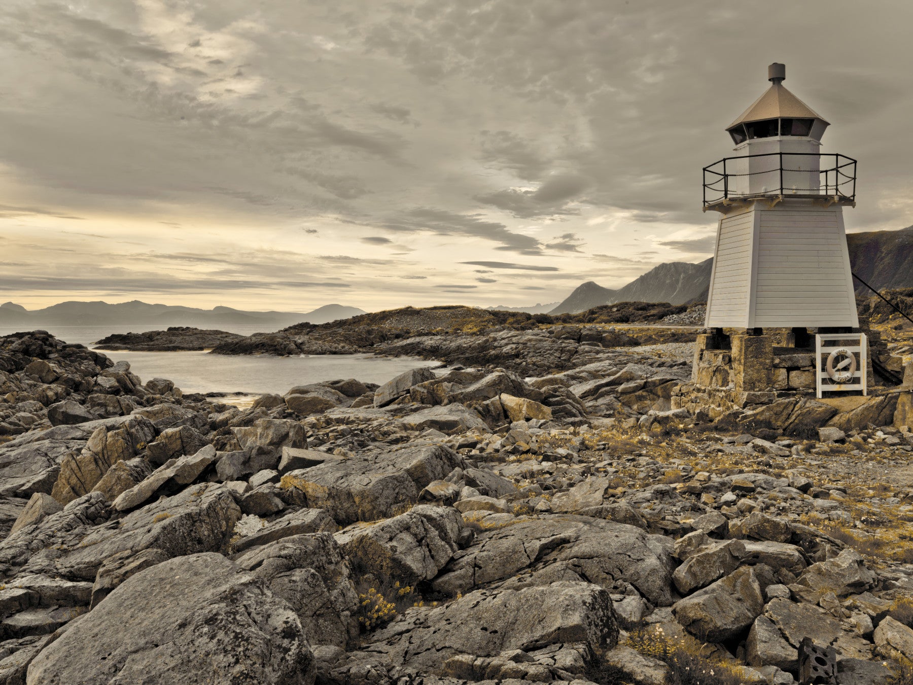 Guardian of the Coast wall mural featuring a lone lighthouse overlooking a rocky shoreline under a moody sky.