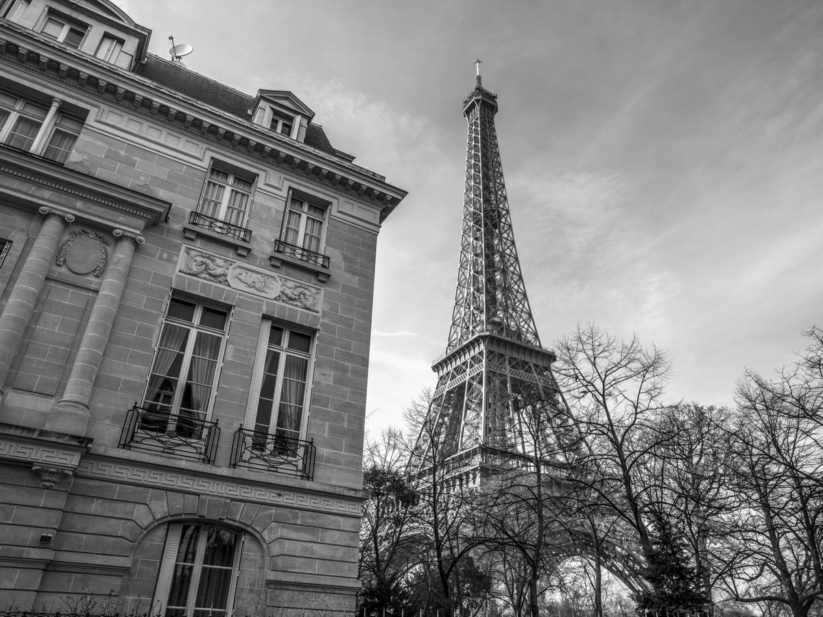 Old building next to Eiffel tower Wall Mural in your room