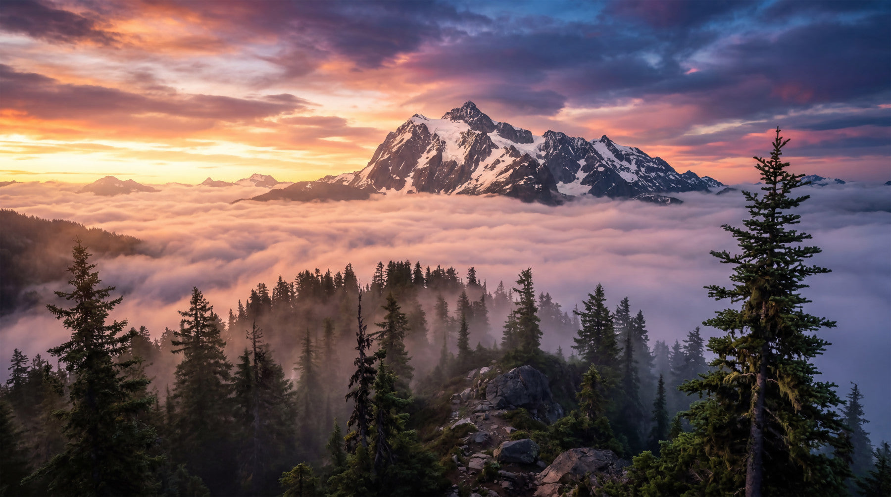 Bedroom wall mural featuring alpine peaks and soft cloud layer scenery
