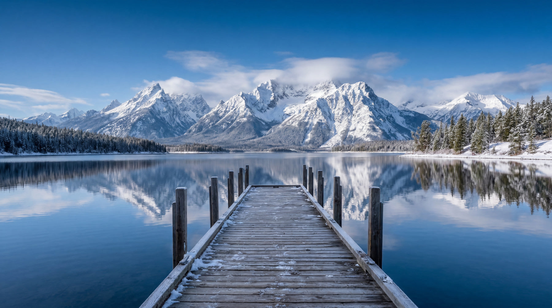 Dining room wall mural with winter peaks and clear lake reflection