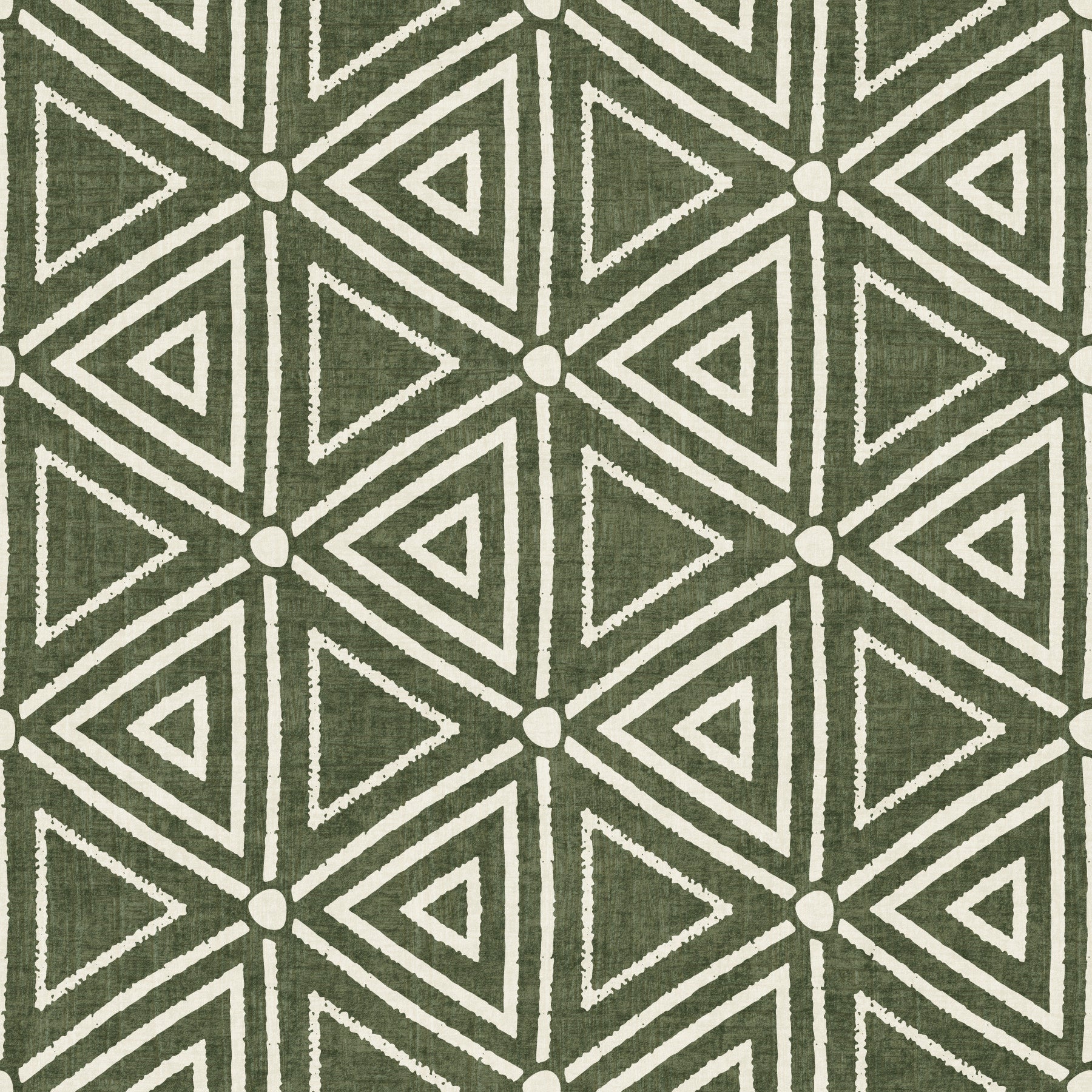 Moss green triangle wallpaper behind a calm bedroom in a boho, earthy scheme
