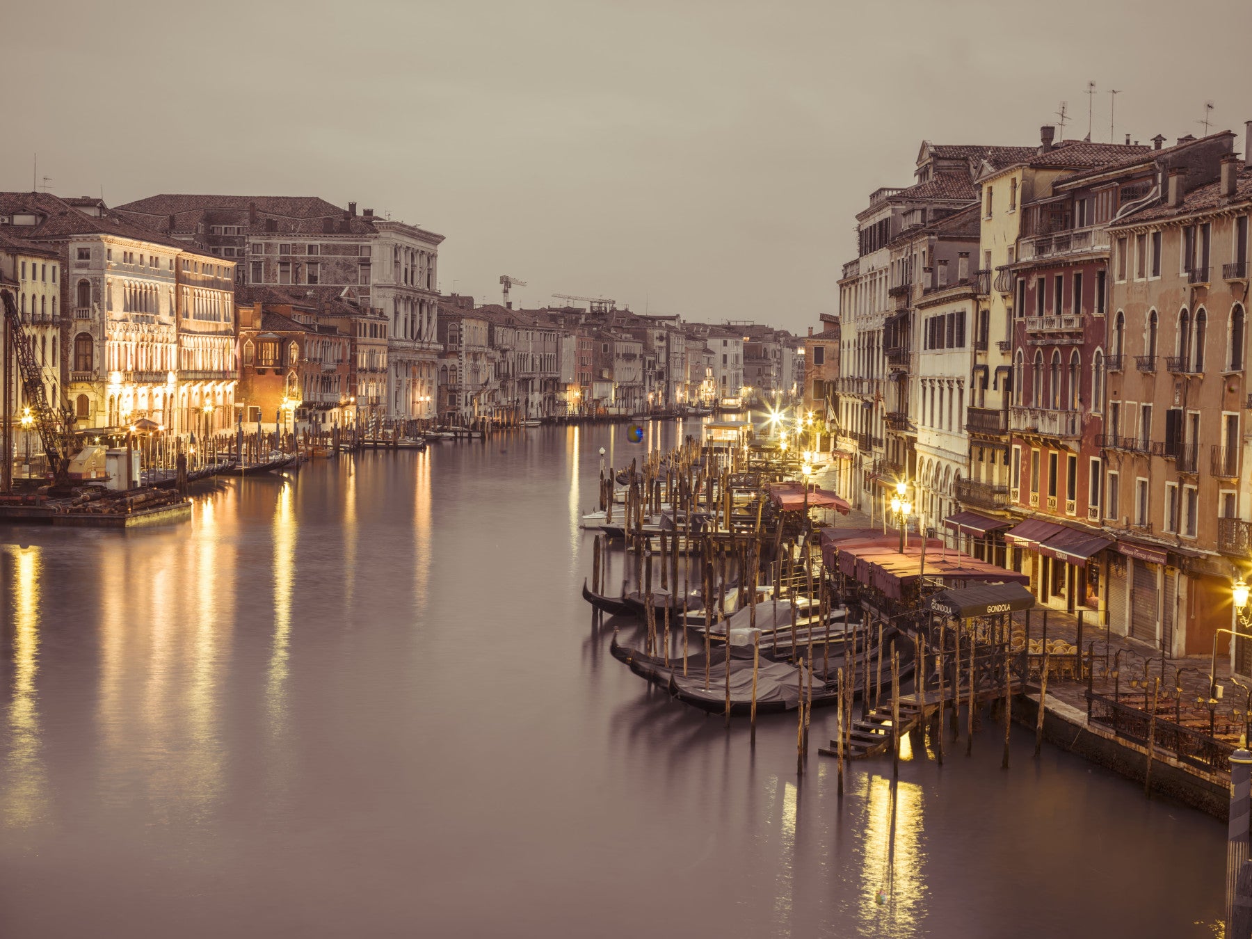 Gondolas rest along the dining room in this Venetian Grand Canal wall mural
