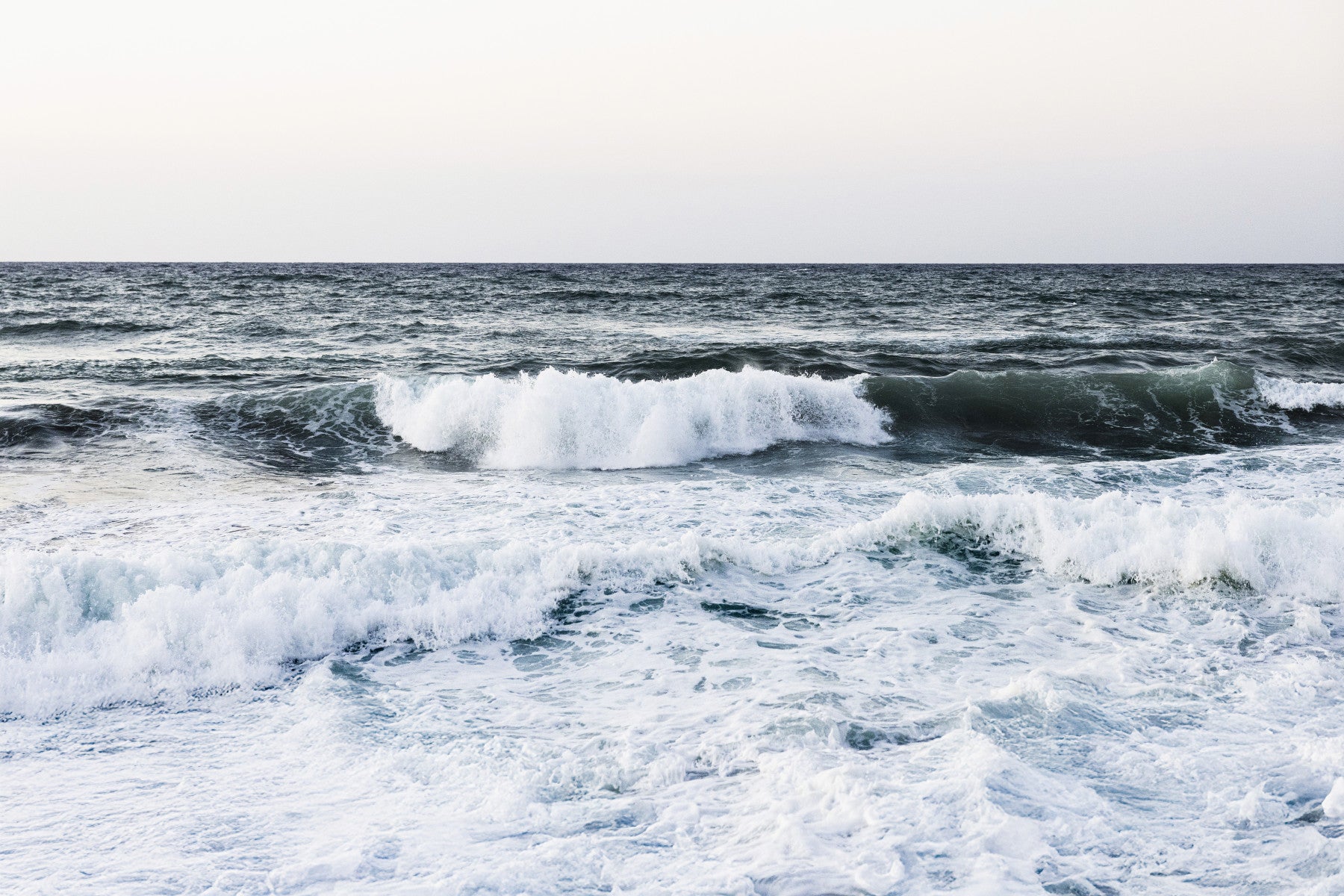 Large blue water swells display on the Ocean Scapes Wall Mural within the bathroom.